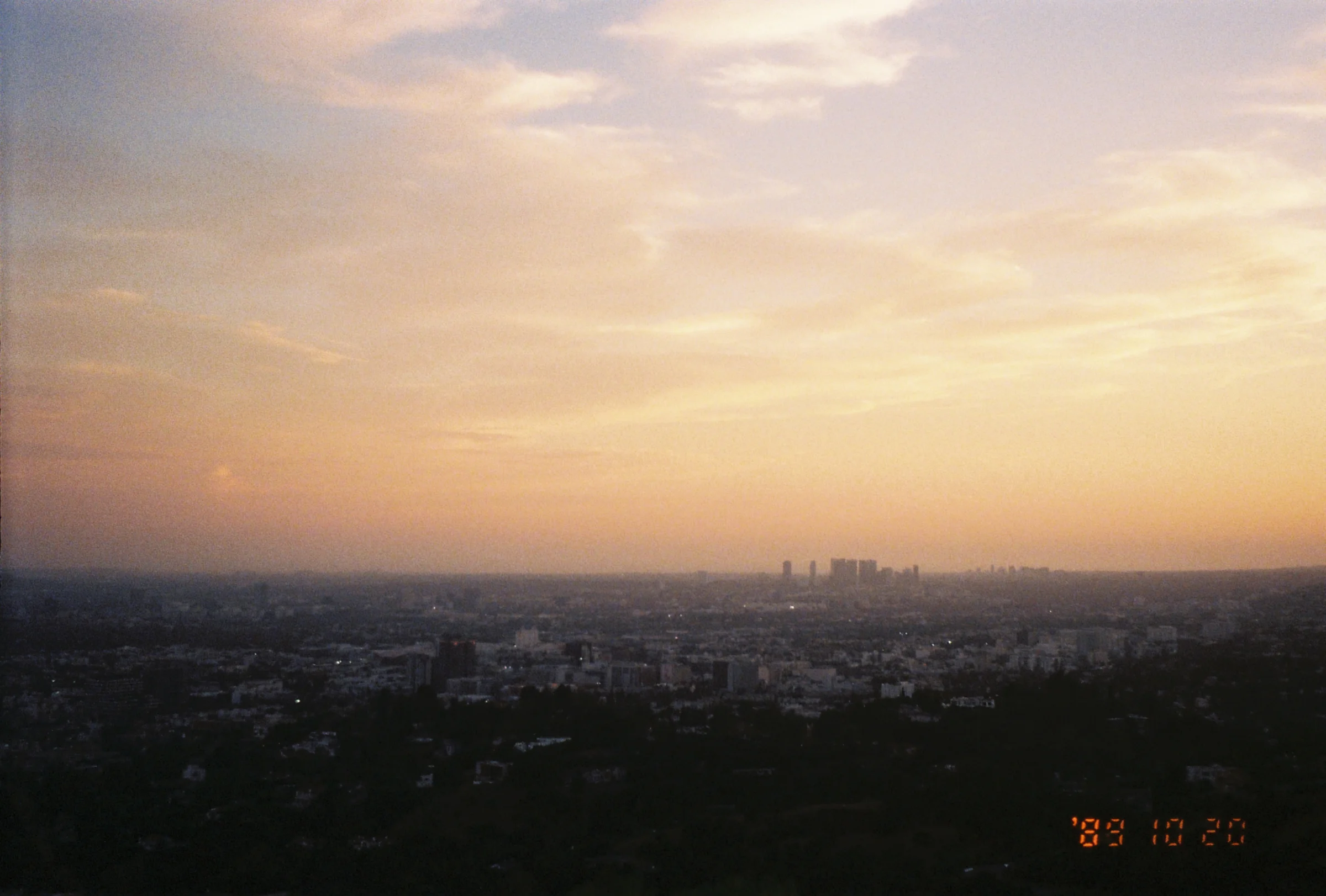 A hazy downtown LA at sunset, with its iconic orange sky.