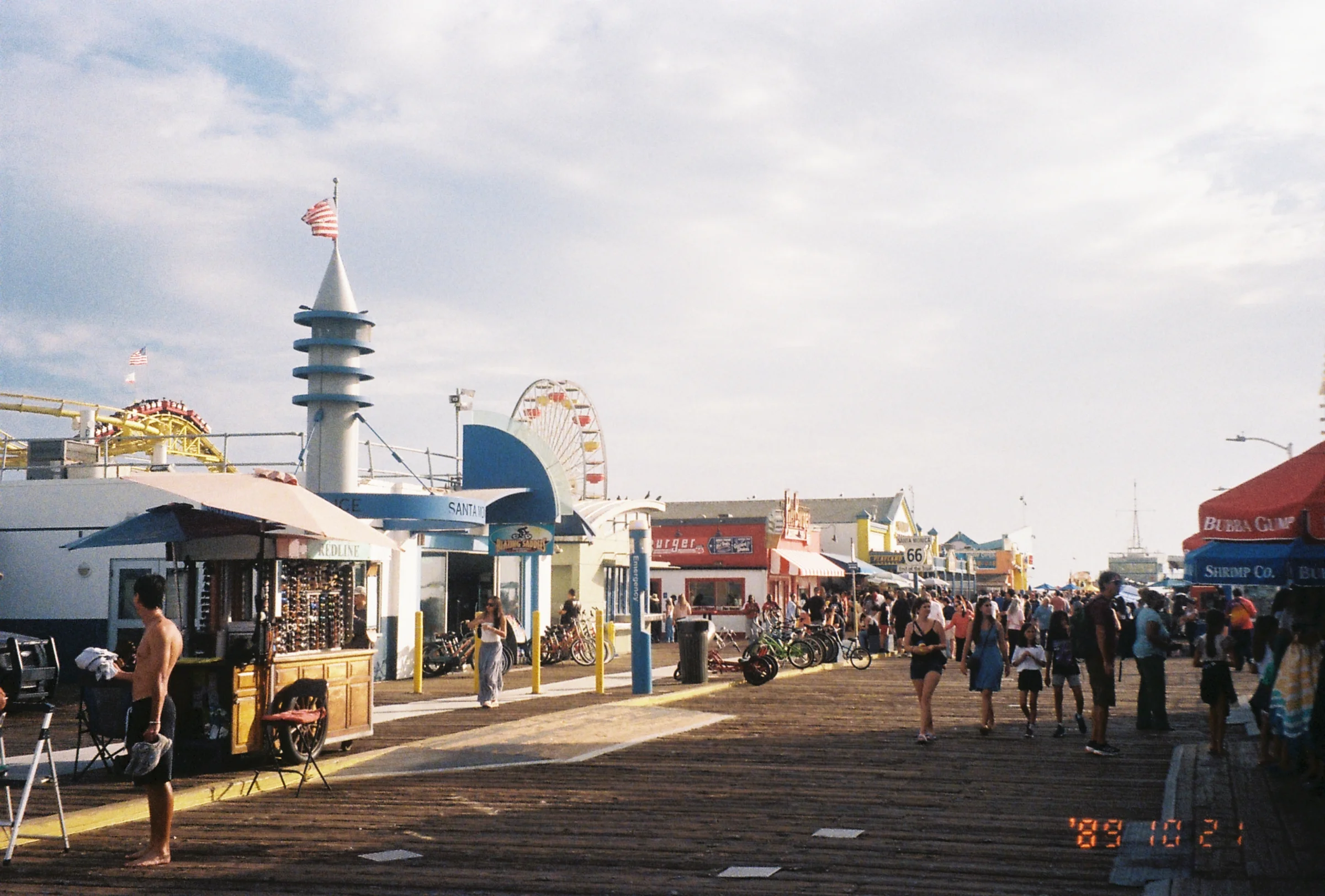 A busy pier on the coast of LA, on a sunny day.
